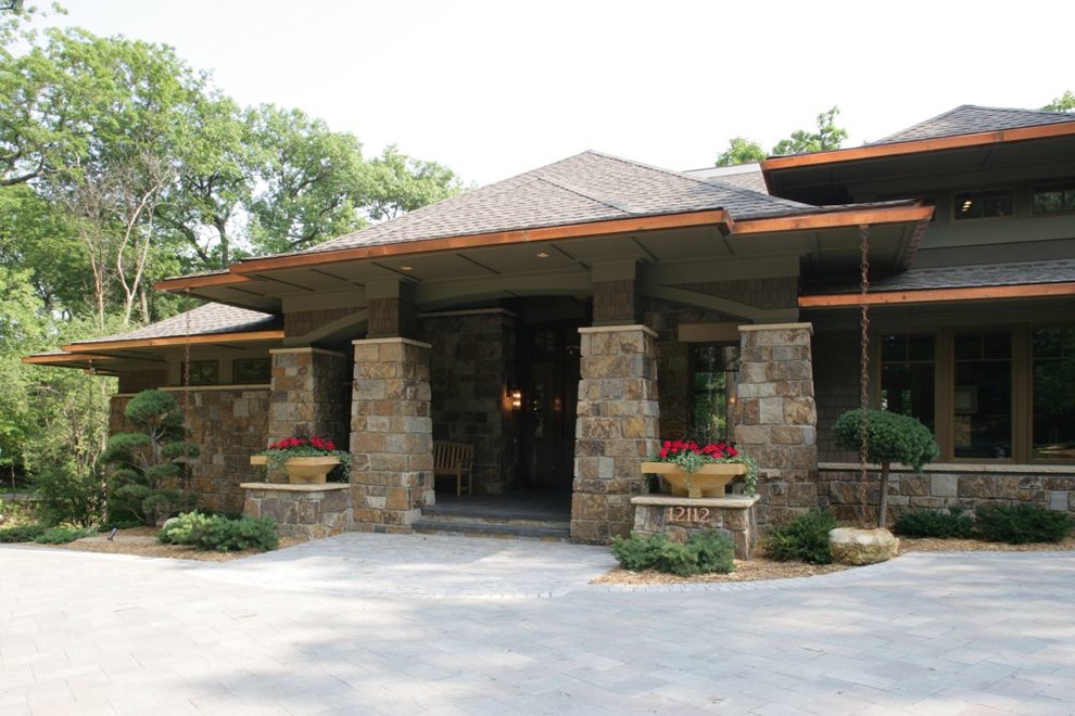 Inspiration for a large asian one-storey brown house exterior in Minneapolis with stone veneer, a hip roof and a shingle roof.