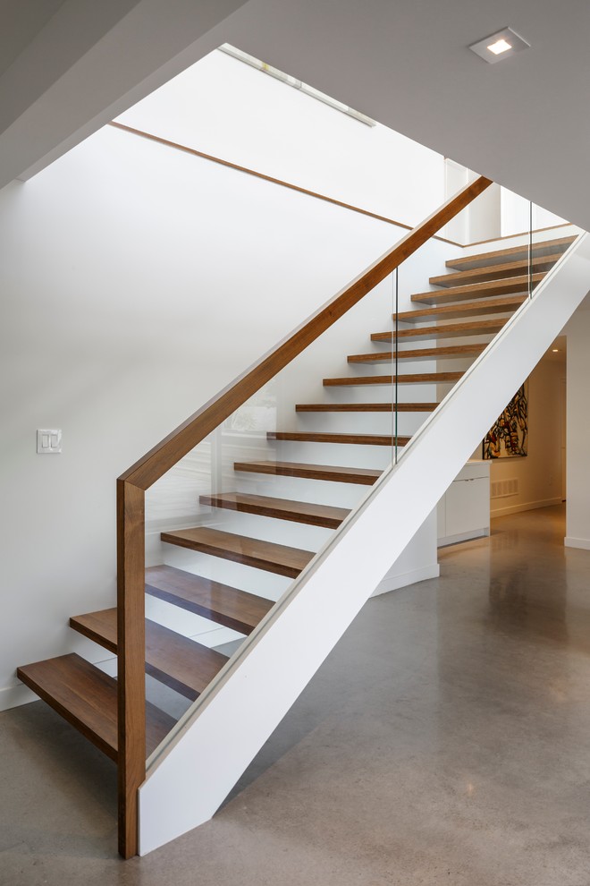 Photo of a mid-sized contemporary wood straight staircase in Ottawa with open risers.