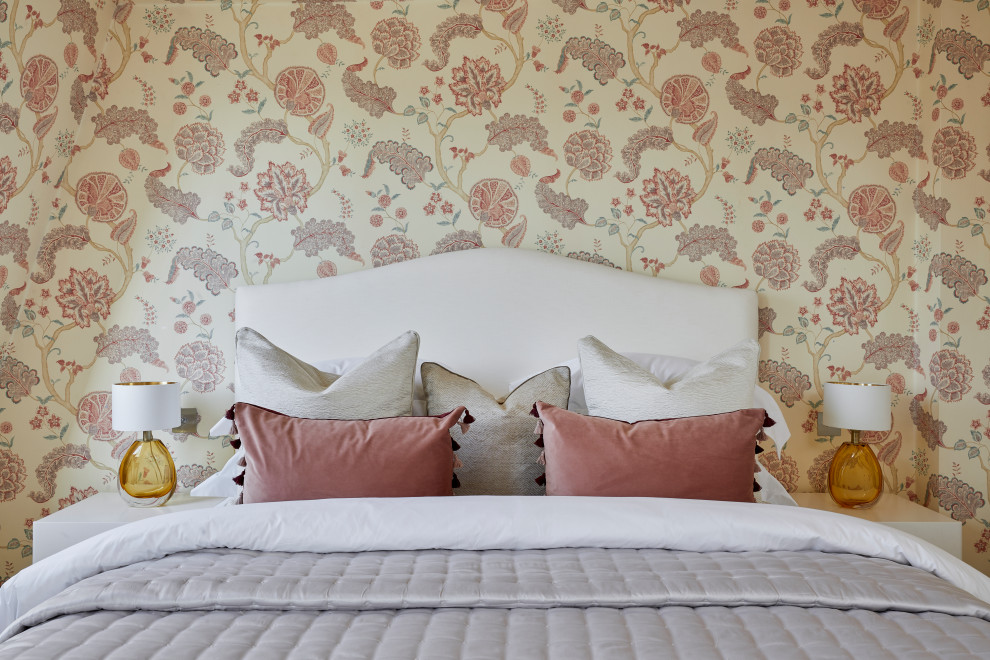 This is an example of a medium sized bohemian master and grey and pink bedroom in London with a feature wall.