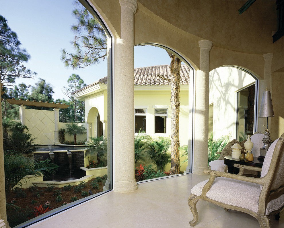 Design ideas for a large mediterranean sunroom in Miami with travertine floors, no fireplace and a standard ceiling.