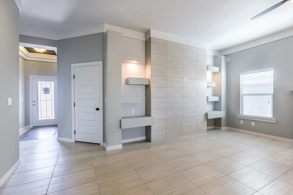 Example of a mid-sized transitional open concept ceramic tile home design design in Austin with gray walls and a media wall