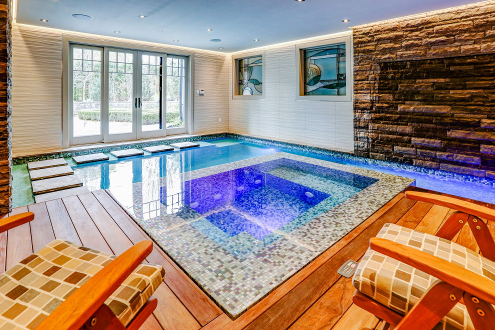 Inspiration for a small eclectic indoor rectangular pool in Toronto with a hot tub and decking.