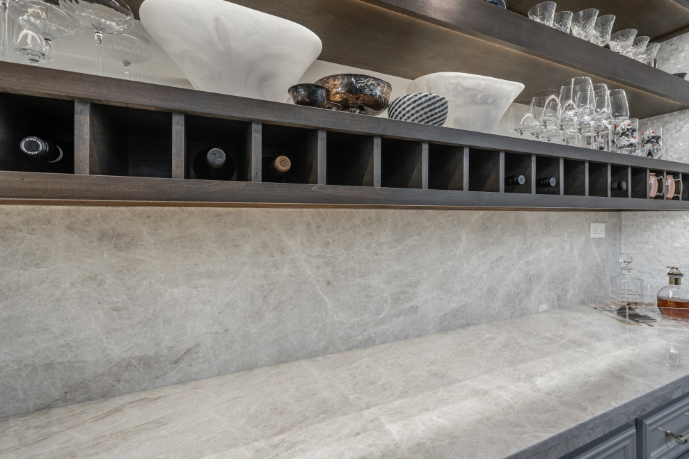 Medium sized traditional home bar in Houston with floating shelves, grey cabinets, granite worktops, multi-coloured splashback, mosaic tiled splashback and multicoloured worktops.