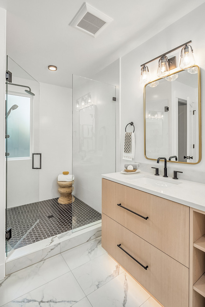Photo of a large beach style master bathroom in Seattle with flat-panel cabinets, light wood cabinets, an alcove shower, white tile, porcelain tile, white walls, porcelain floors, an undermount sink, quartzite benchtops, white floor, a hinged shower door, white benchtops, a double vanity and a built-in vanity.