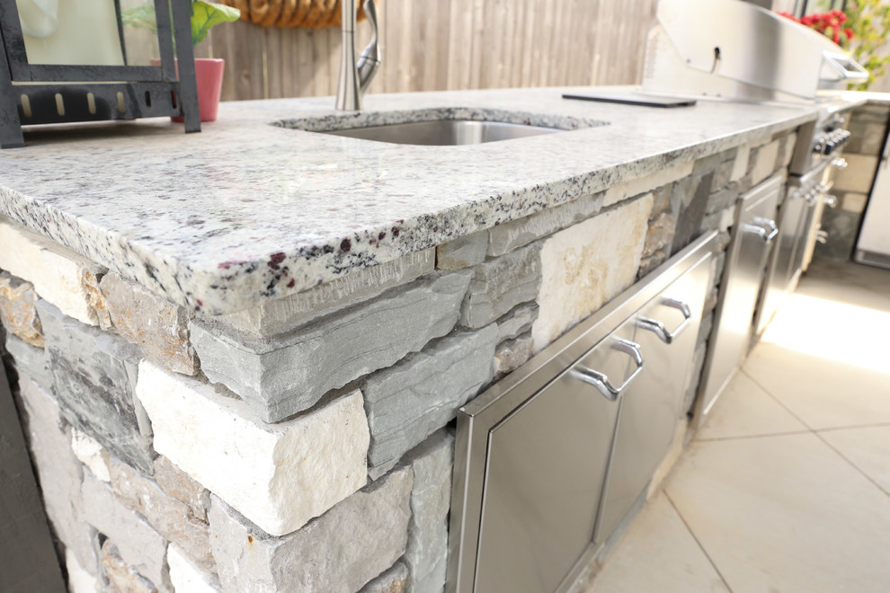 Large transitional backyard tile patio kitchen photo with a gazebo