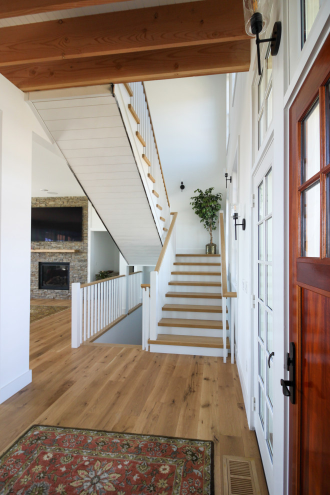 Inspiration for a mid-sized country wooden u-shaped wood railing and shiplap wall staircase remodel in DC Metro with wooden risers