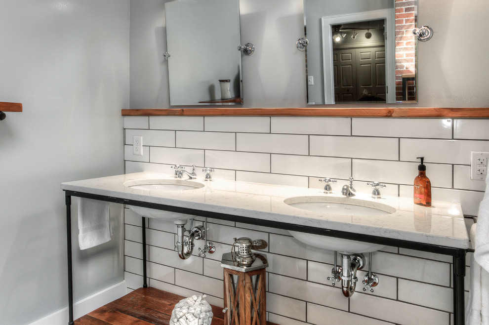 Inspiration for a large transitional master bathroom in Omaha with open cabinets, medium wood cabinets, an open shower, a one-piece toilet, white tile, subway tile, grey walls, mosaic tile floors, an undermount sink and marble benchtops.
