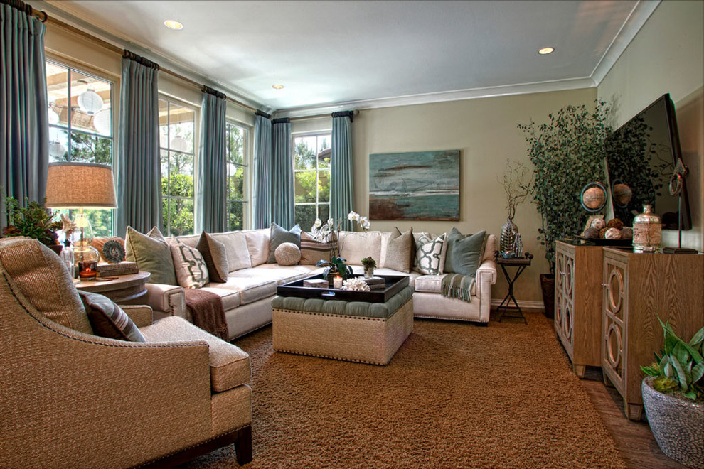 Mid-sized transitional open concept family room in Los Angeles with beige walls, light hardwood floors and a wall-mounted tv.