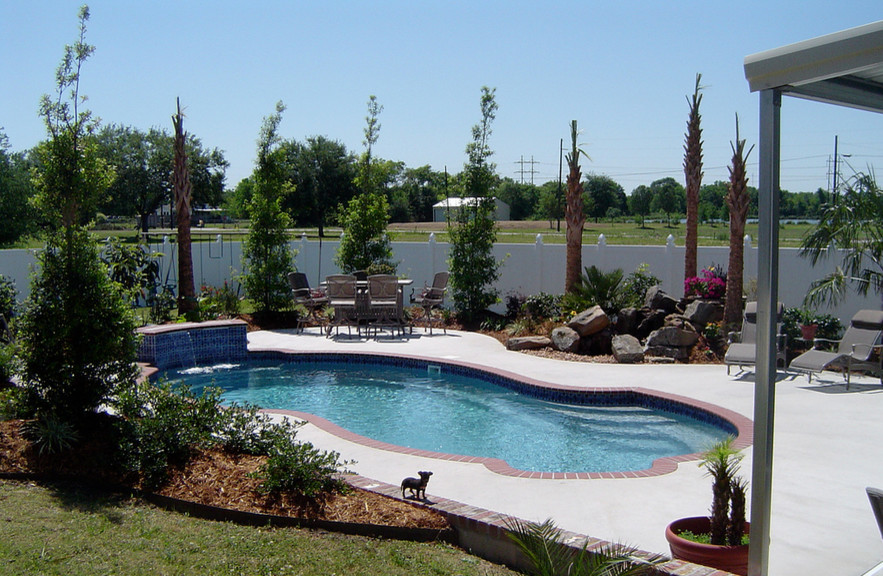Example of a large transitional backyard concrete and custom-shaped hot tub design in St Louis