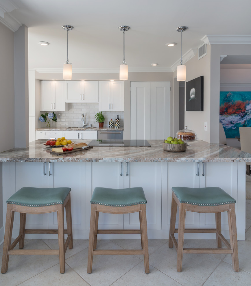 Mid-sized transitional galley porcelain tile eat-in kitchen photo in Miami with an undermount sink, shaker cabinets, white cabinets, granite countertops, white backsplash, subway tile backsplash, stainless steel appliances and a peninsula