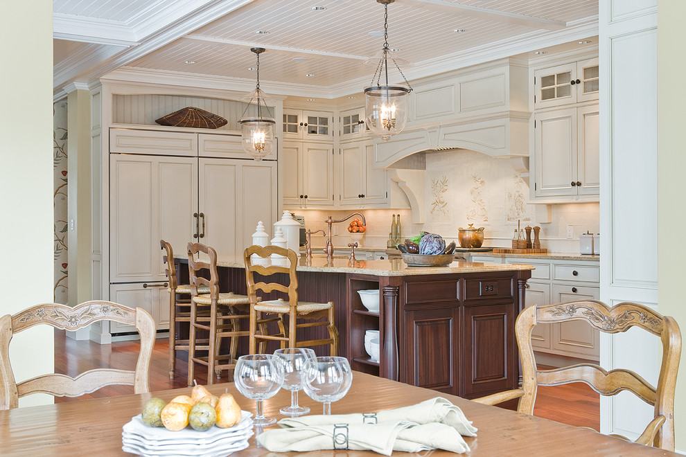This is an example of a traditional kitchen in Boston with raised-panel cabinets, beige cabinets and panelled appliances.