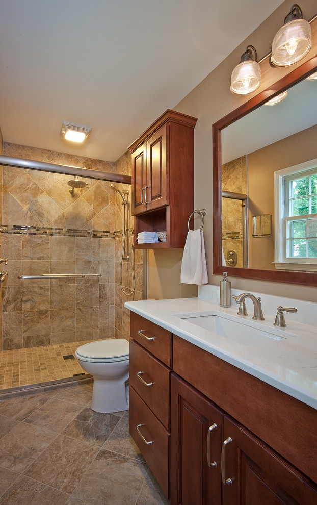 Design ideas for a small contemporary master bathroom in Raleigh with an undermount sink, raised-panel cabinets, medium wood cabinets, quartzite benchtops, an alcove shower, a two-piece toilet, beige tile, porcelain tile, beige walls, porcelain floors, brown floor, a sliding shower screen and white benchtops.