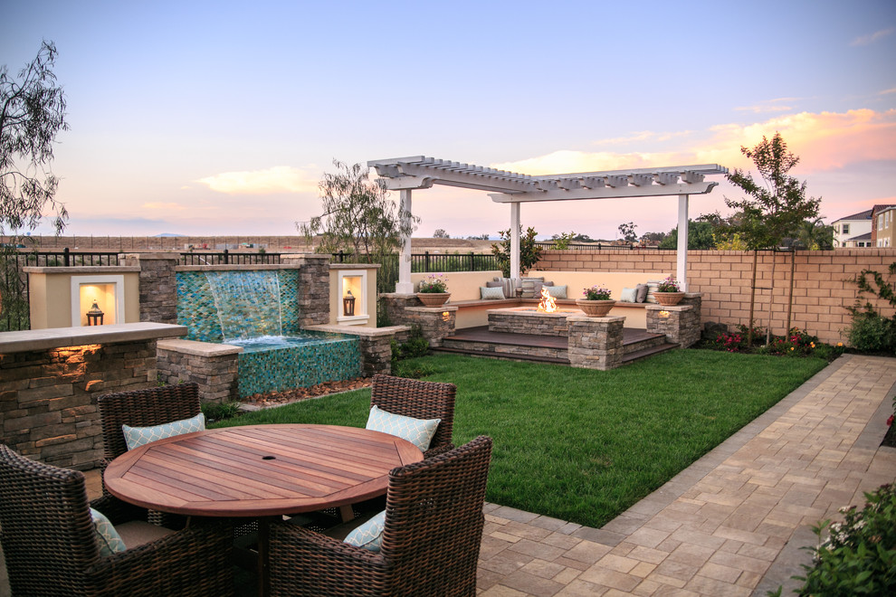 Photo of a large transitional backyard garden in San Diego with a water feature and concrete pavers.