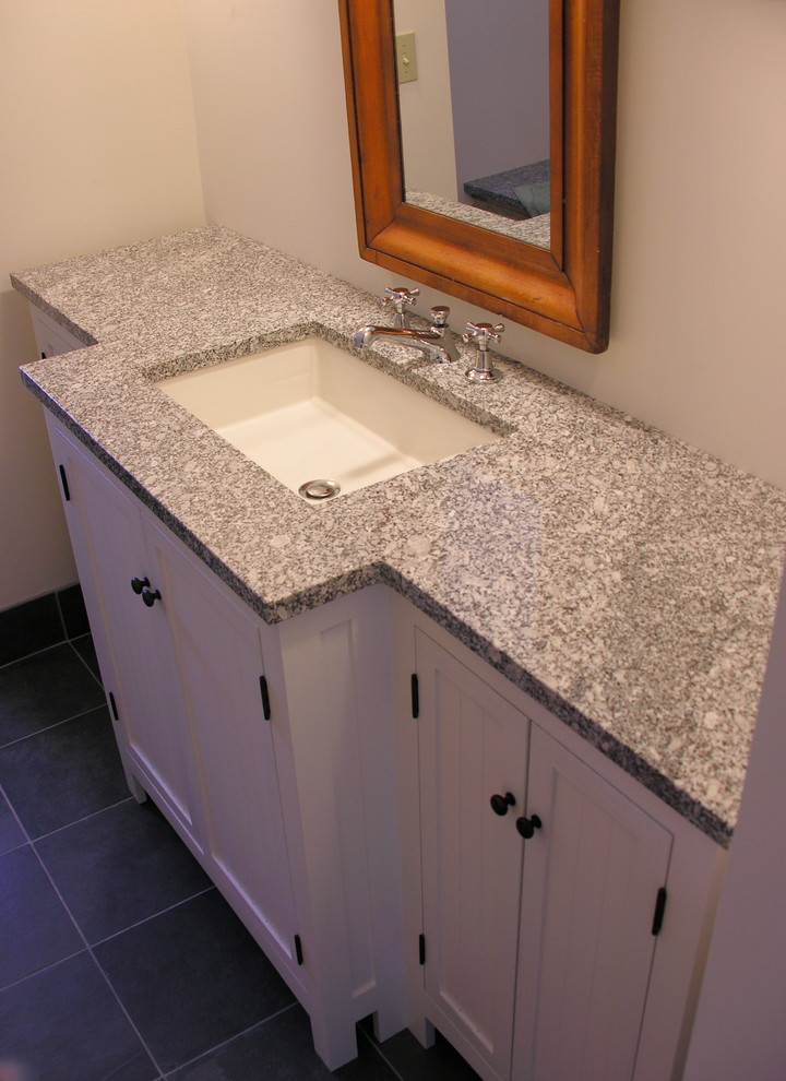 This is an example of a large traditional master bathroom in Portland Maine with beaded inset cabinets, white cabinets, granite benchtops, gray tile, stone tile, white walls and slate floors.