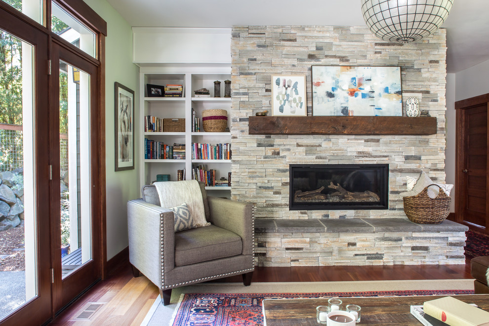 Design ideas for a transitional living room in Portland with white walls, dark hardwood floors, a ribbon fireplace, a stone fireplace surround and brown floor.