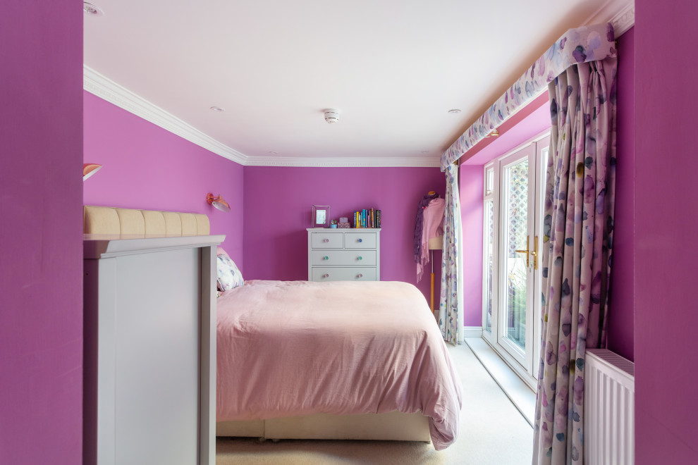 This is an example of a mid-sized contemporary master bedroom in Gloucestershire with purple walls, carpet, no fireplace and beige floor.