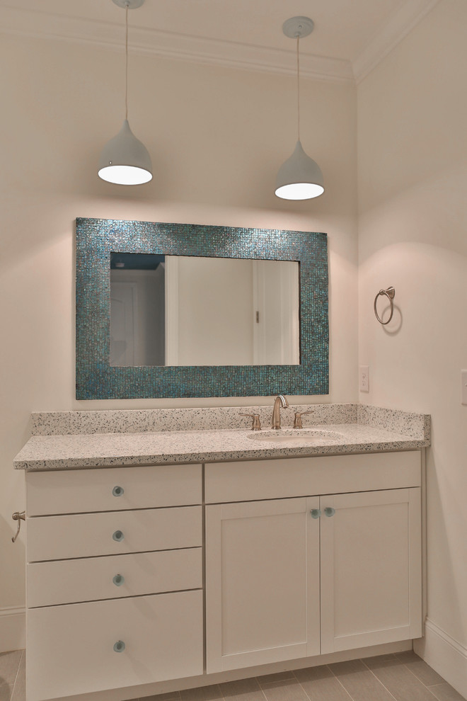 Inspiration for an arts and crafts bathroom in Raleigh with shaker cabinets, white cabinets, white walls, ceramic floors, an undermount sink, terrazzo benchtops and beige floor.