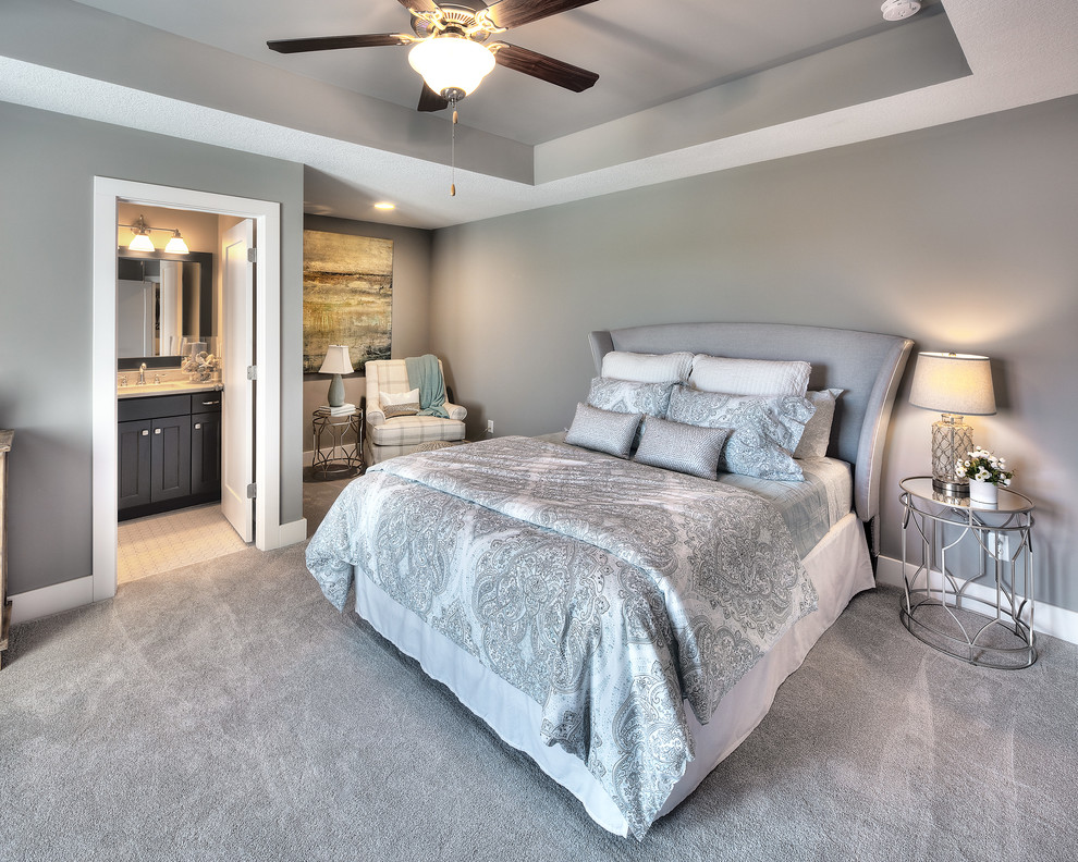 This is an example of a transitional master bedroom in Kansas City with grey walls, carpet and grey floor.