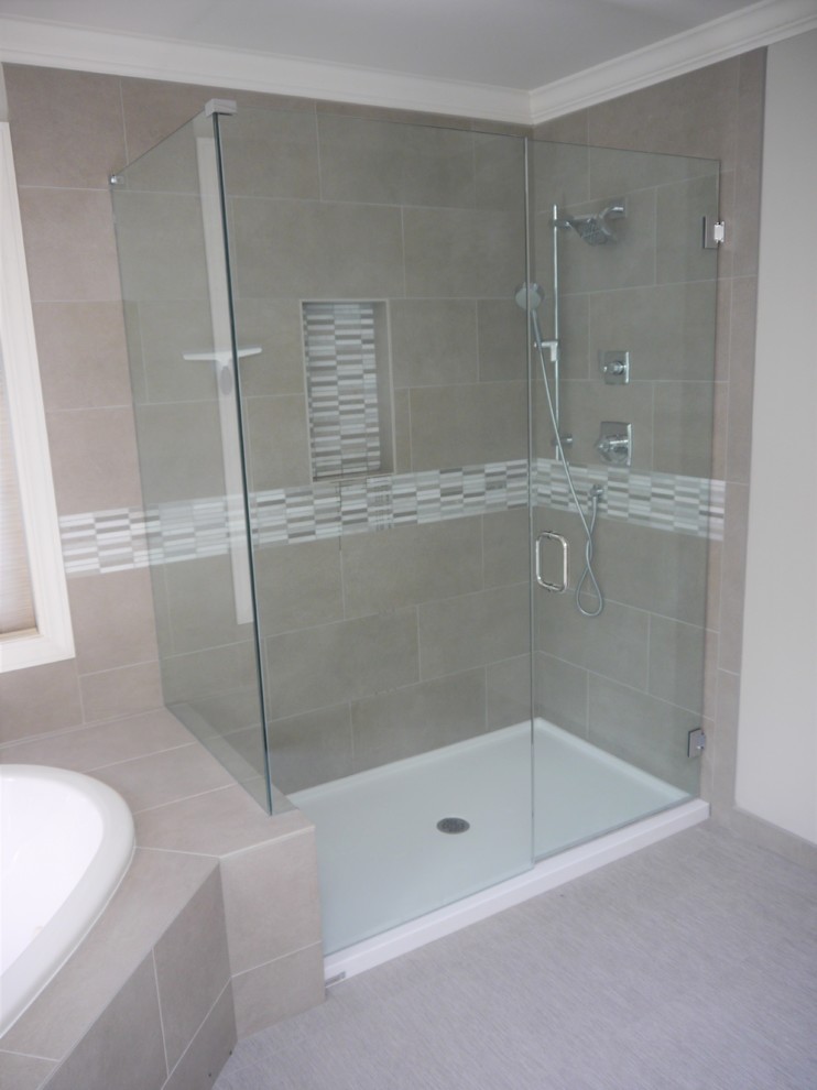 This is an example of a large transitional master bathroom in Seattle with shaker cabinets, white cabinets, a drop-in tub, gray tile, porcelain tile, grey walls, linoleum floors, an undermount sink, engineered quartz benchtops, grey floor, a hinged shower door and grey benchtops.