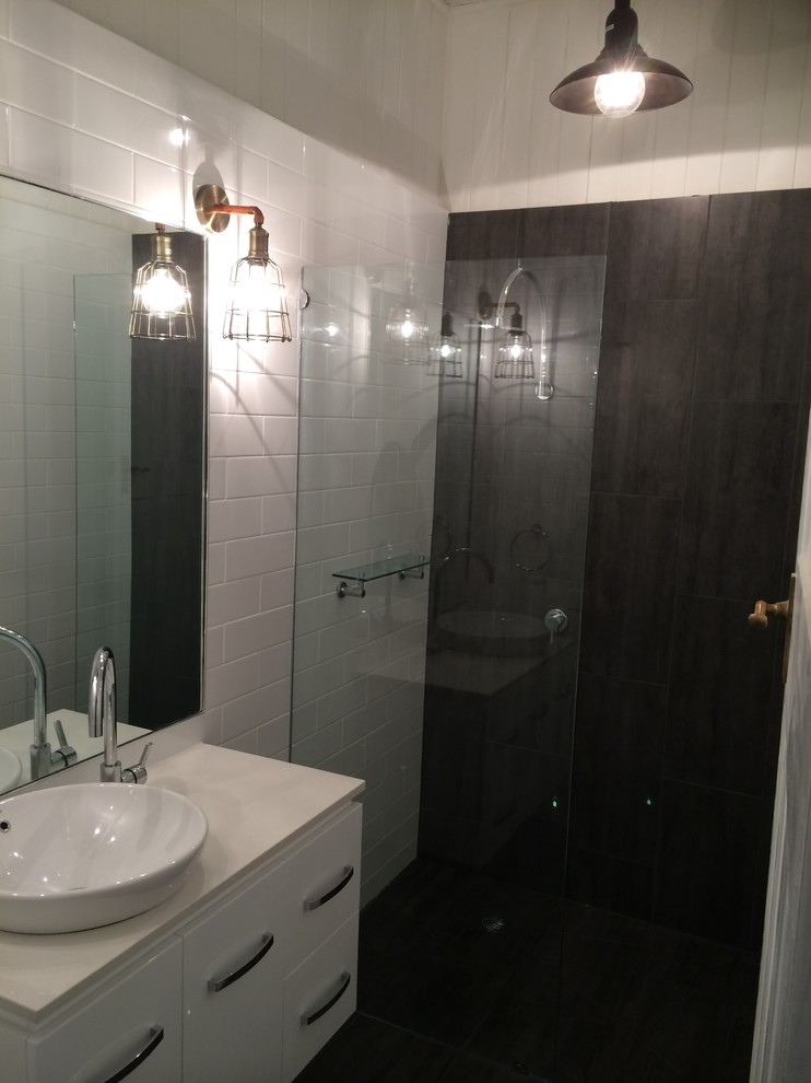 Small industrial bathroom in Brisbane with granite benchtops.