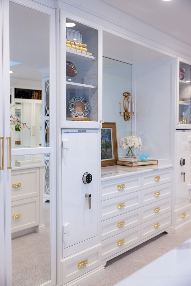 Large traditional women's walk-in wardrobe in Other with white cabinets and carpet.