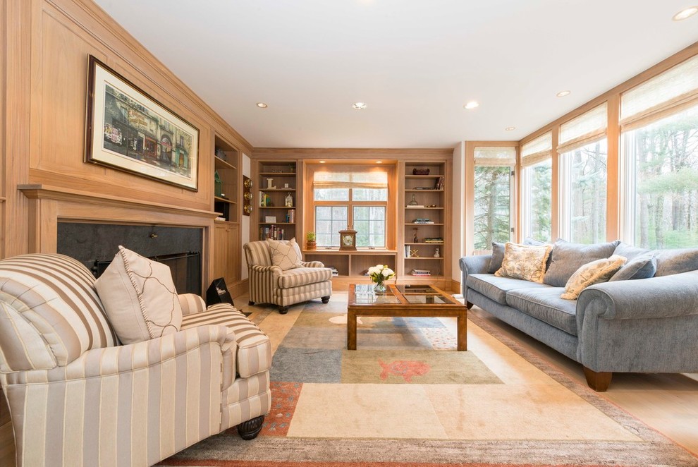 Design ideas for a mid-sized traditional enclosed family room in Boston with a library, white walls, carpet, a standard fireplace and a wood fireplace surround.
