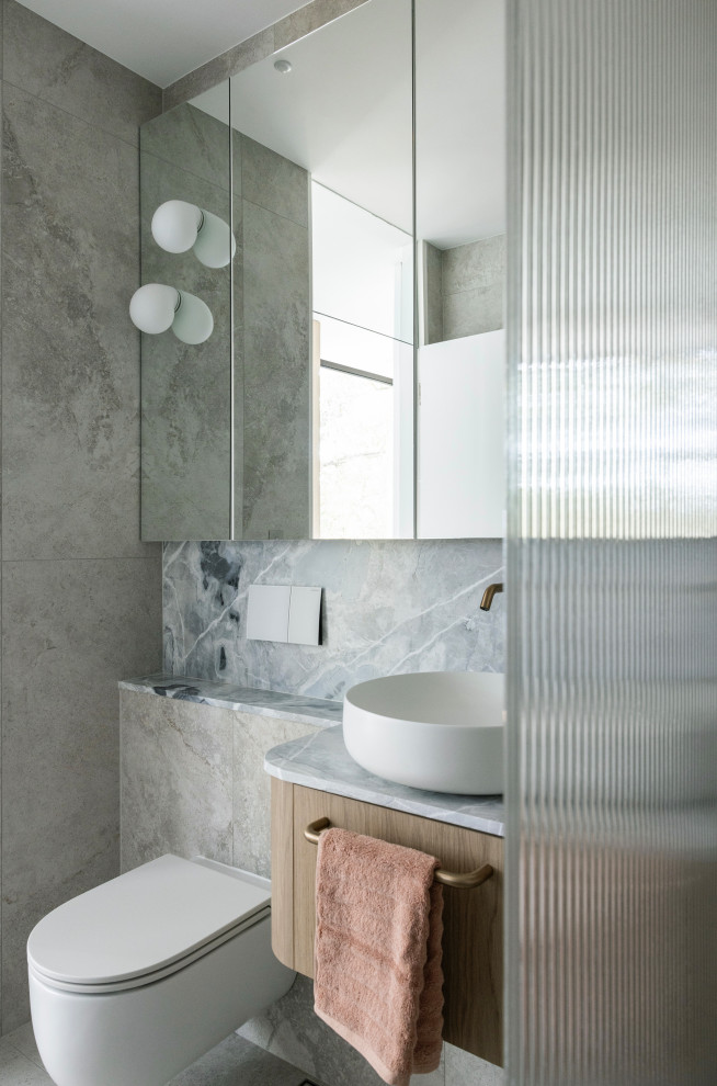 Design ideas for a large contemporary bathroom in Sydney with flat-panel cabinets, medium wood cabinets, a freestanding tub, an open shower, a wall-mount toilet, beige tile, porcelain tile, beige walls, porcelain floors, a vessel sink, quartzite benchtops, beige floor, blue benchtops, a niche and a single vanity.