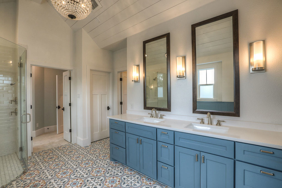 Large transitional master bathroom in Orange County with shaker cabinets, blue cabinets, a freestanding tub, a corner shower, white tile, ceramic tile, white walls, ceramic floors, an undermount sink, engineered quartz benchtops and white benchtops.