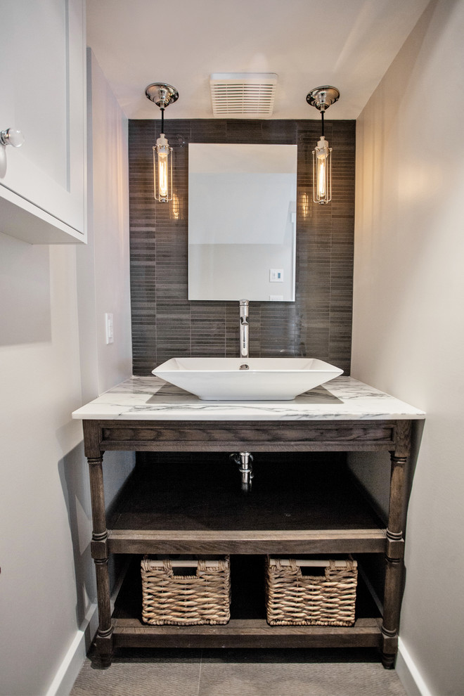 Inspiration for a contemporary powder room in Toronto with a vessel sink, open cabinets, gray tile and grey walls.