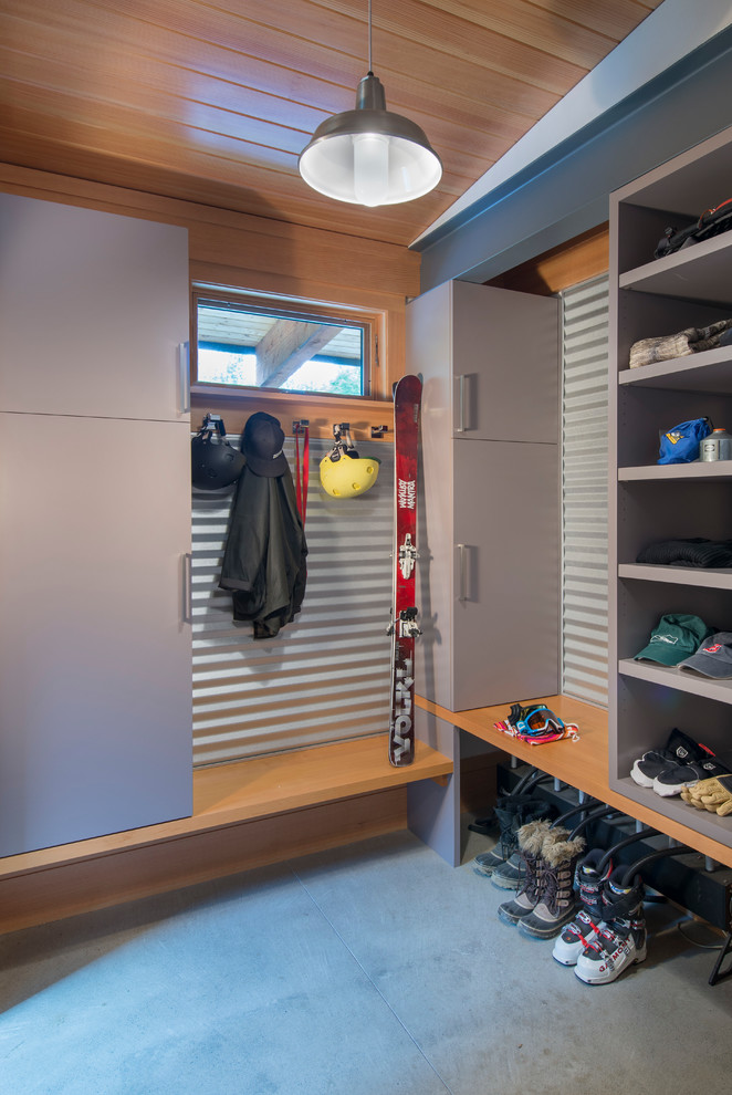 Mid-sized contemporary storage and wardrobe in Burlington with concrete floors, flat-panel cabinets and grey cabinets.