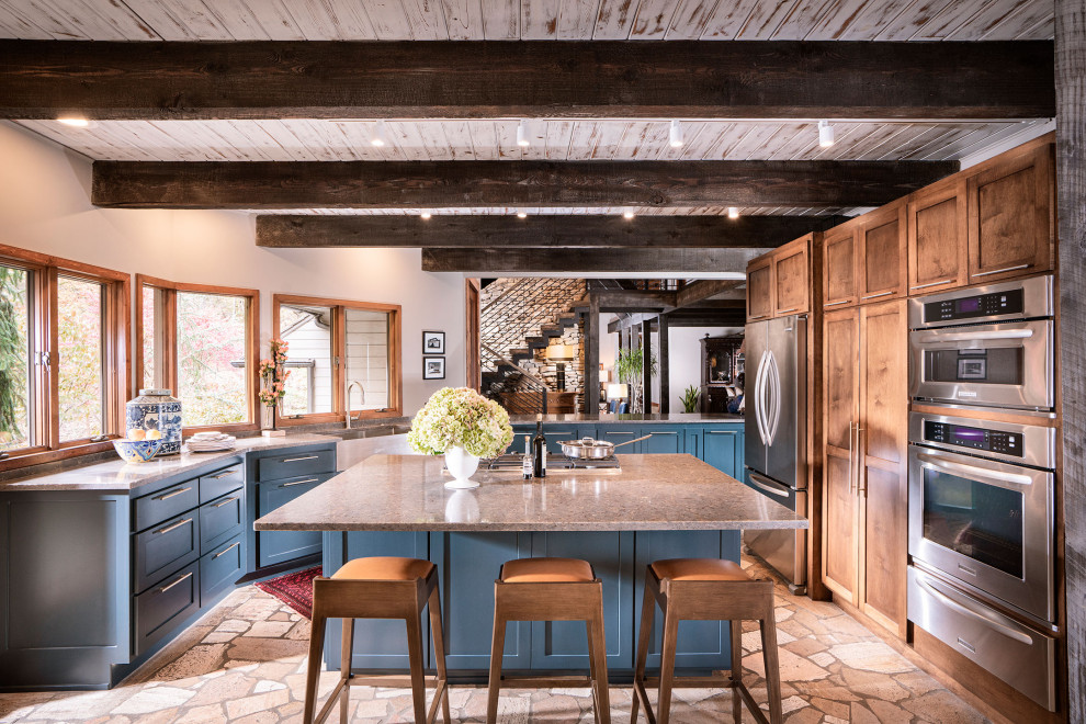 Expansive country u-shaped kitchen in Other with shaker cabinets, blue cabinets, quartz benchtops, with island, a farmhouse sink, stainless steel appliances and grey benchtop.