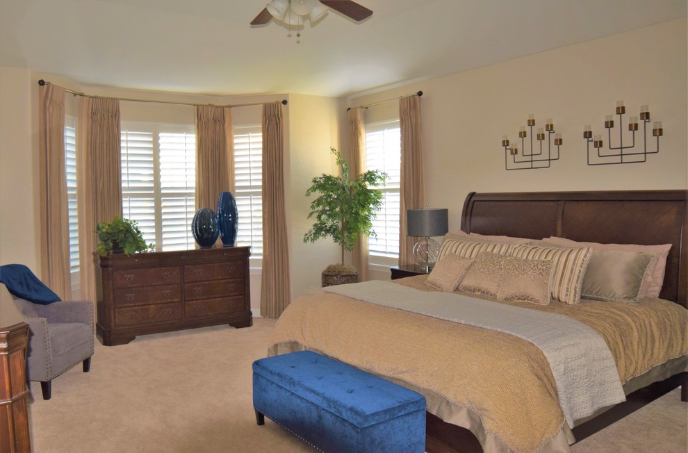 Photo of a large transitional master bedroom in Denver with grey walls and carpet.