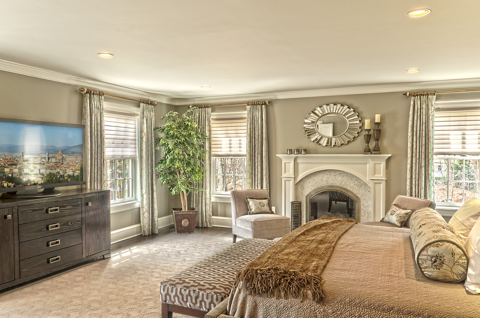 Design ideas for a mid-sized master bedroom in New York with beige walls, dark hardwood floors, a standard fireplace and a stone fireplace surround.