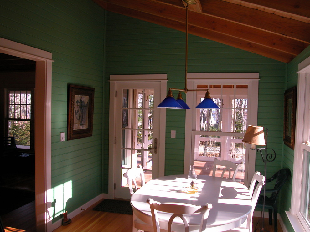 This is an example of a mid-sized traditional separate dining room in Portland Maine with green walls, medium hardwood floors and brown floor.