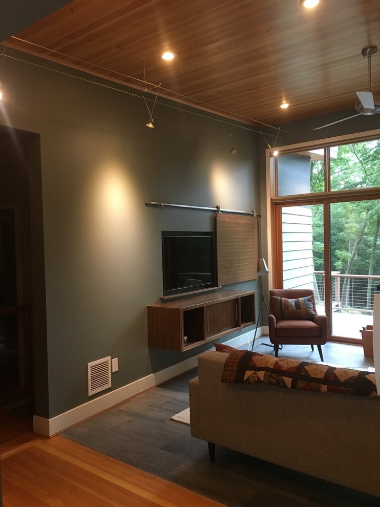 Design ideas for a mid-sized transitional open concept living room in Bridgeport with green walls, slate floors, no fireplace and a wall-mounted tv.