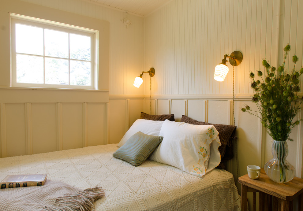 Photo of a beach style bedroom in Portland with beige walls.