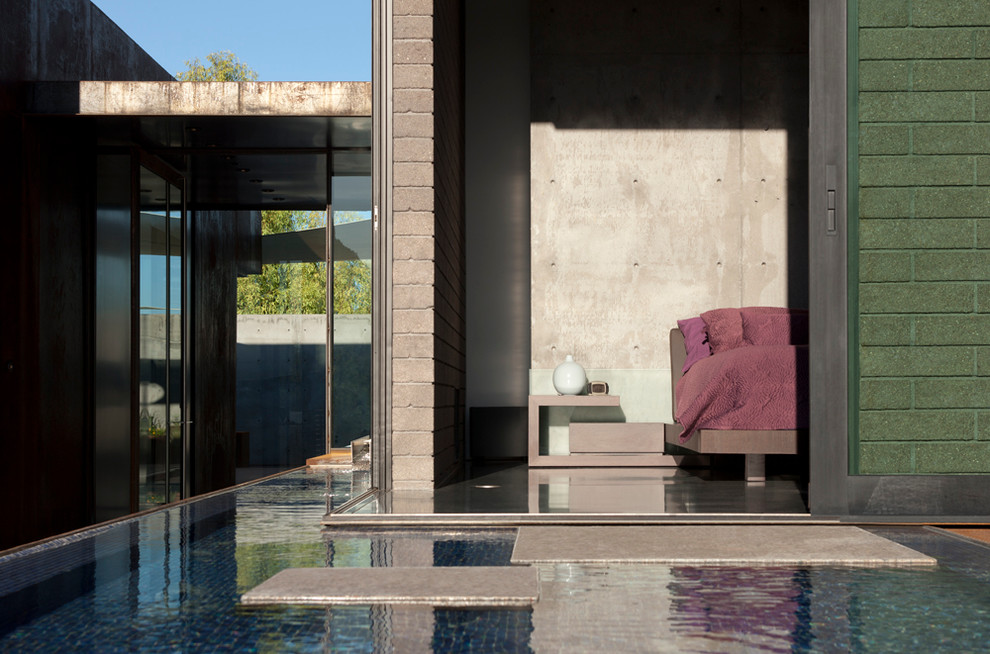 Inspiration for a modern master concrete floor bedroom remodel in Phoenix with gray walls