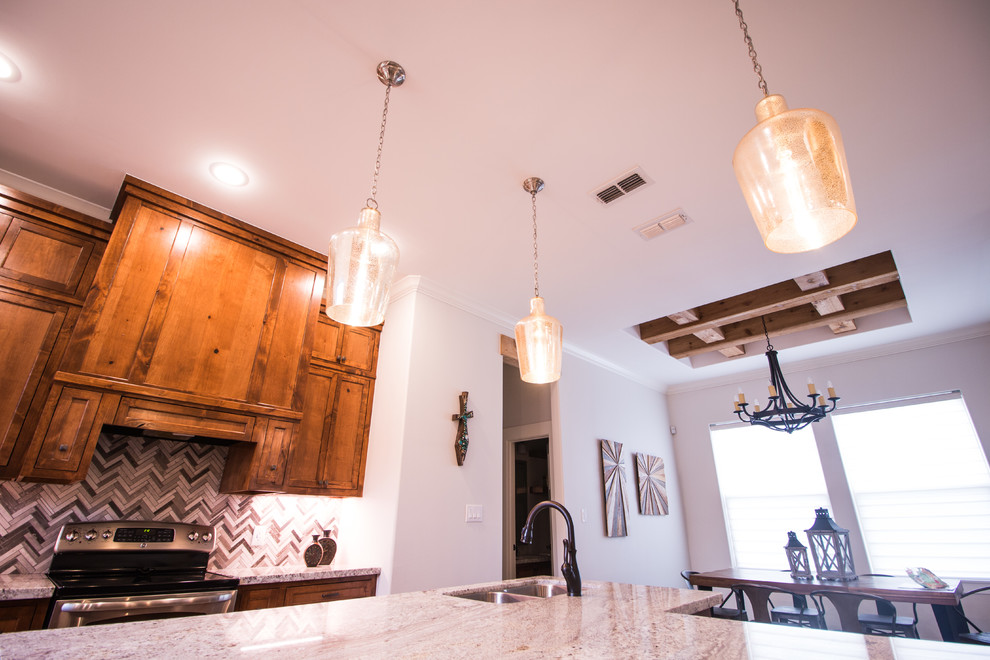 Mid-sized mountain style l-shaped concrete floor and gray floor eat-in kitchen photo with a double-bowl sink, shaker cabinets, granite countertops, gray backsplash, mosaic tile backsplash, stainless steel appliances and an island