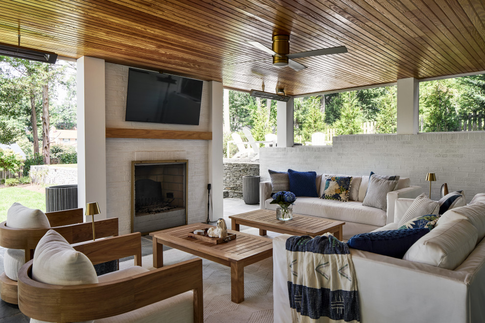 Patio - transitional patio idea in DC Metro with a fireplace and a roof extension
