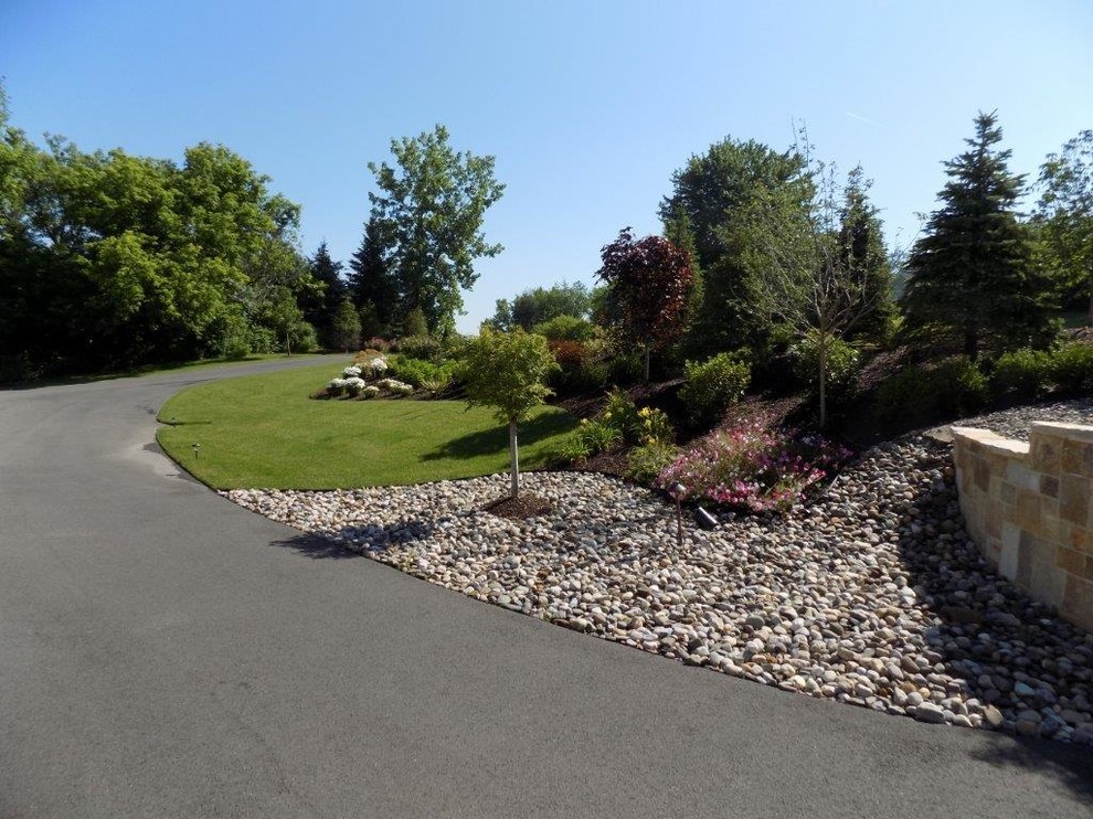 Photo of a large transitional front yard full sun garden in Boston with gravel.