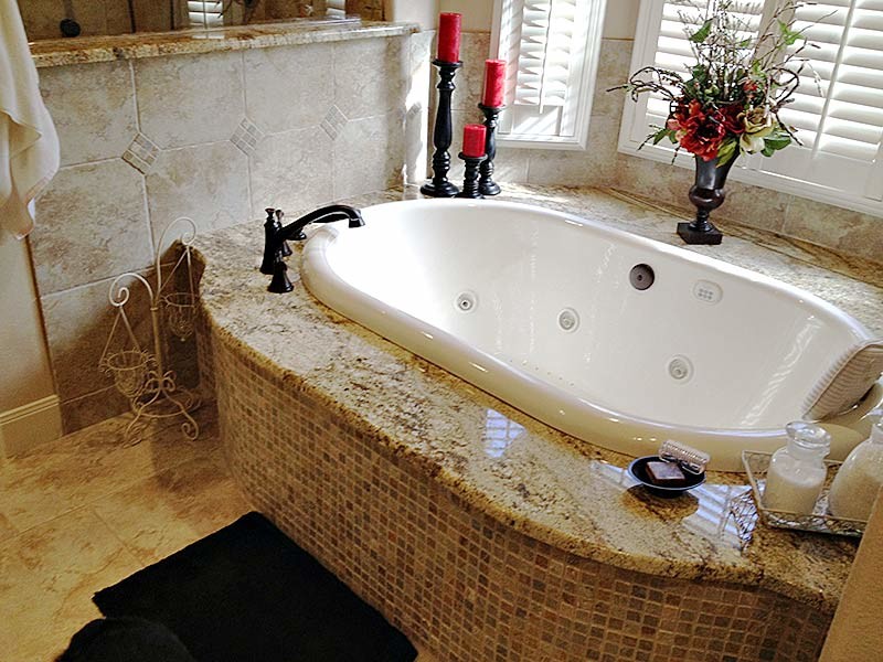Alcove bathtub - transitional alcove bathtub idea in Austin with beige walls