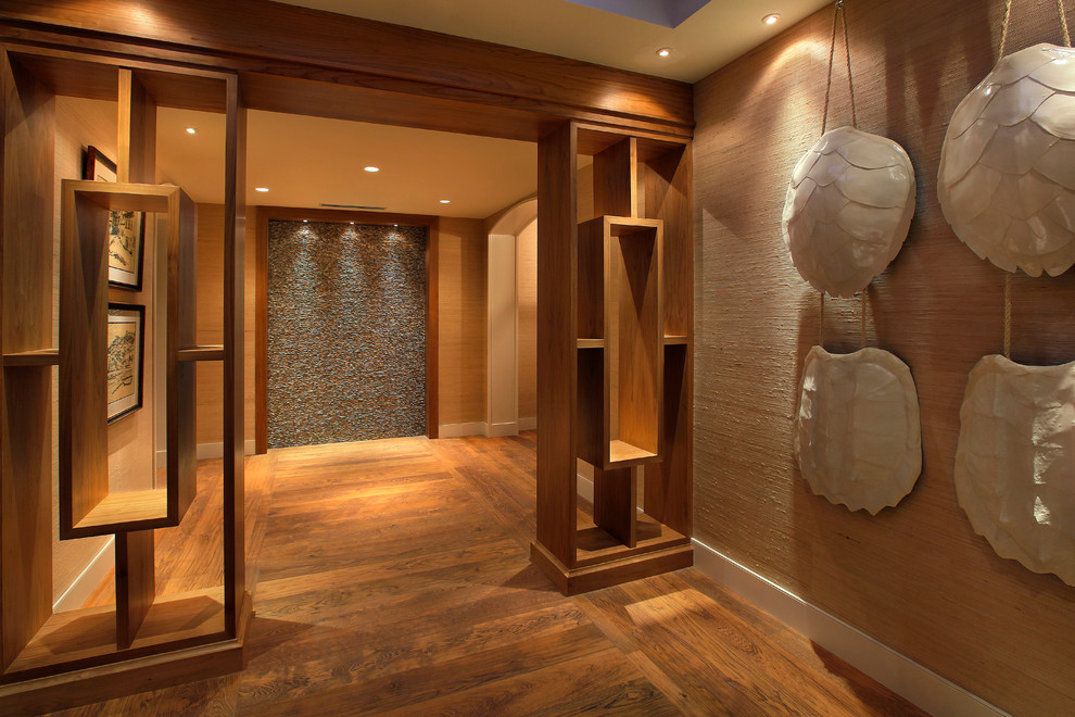 This is an example of a contemporary foyer in Miami with beige walls and medium hardwood floors.