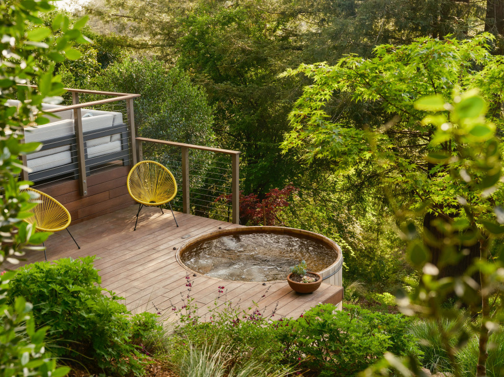 Trendy second story cable railing deck photo in San Francisco with no cover