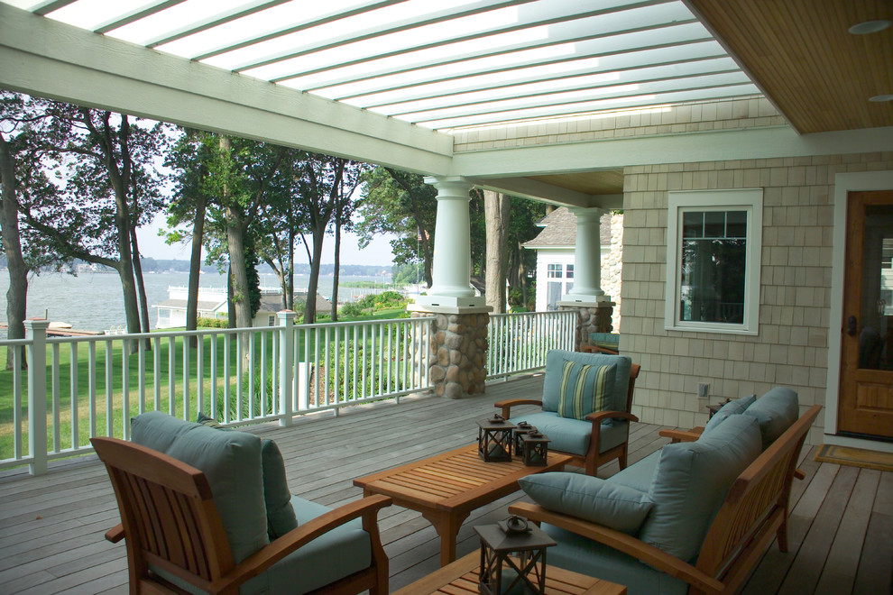 Inspiration for a large transitional backyard verandah in Grand Rapids with decking and a pergola.