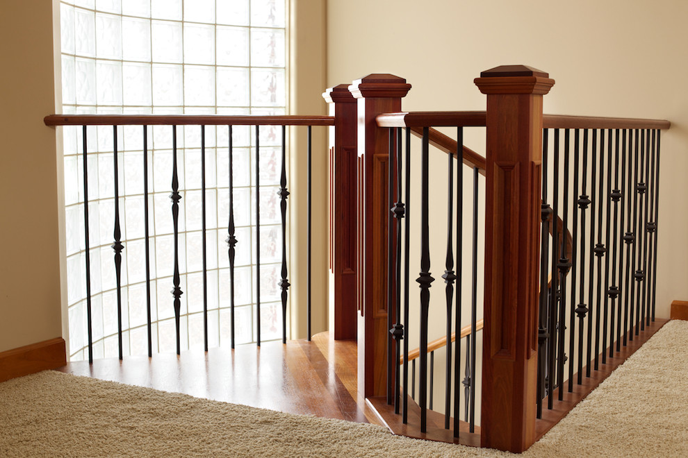Minimalist wooden spiral mixed material railing staircase photo in Edmonton with wooden risers