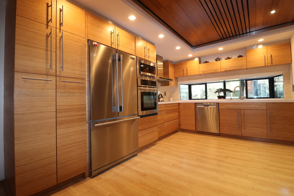 This is an example of a large modern galley eat-in kitchen in Orange County with a double-bowl sink, flat-panel cabinets, light wood cabinets, red splashback, no island, bamboo floors, stainless steel appliances, quartzite benchtops, mosaic tile splashback, beige floor, white benchtop and wood.