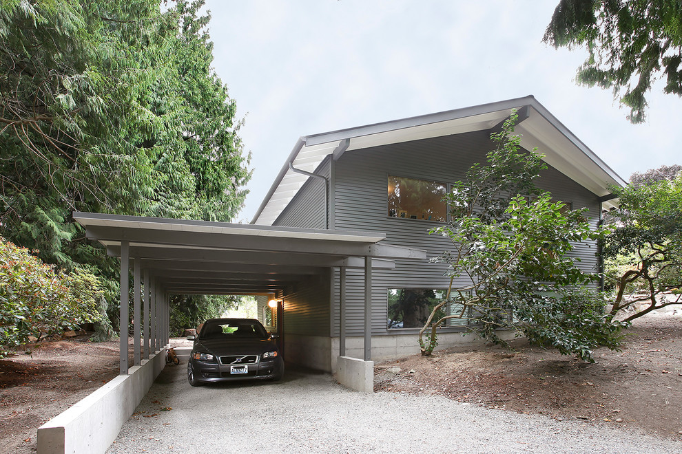 Inspiration for a mid-sized midcentury attached three-car carport in Seattle.