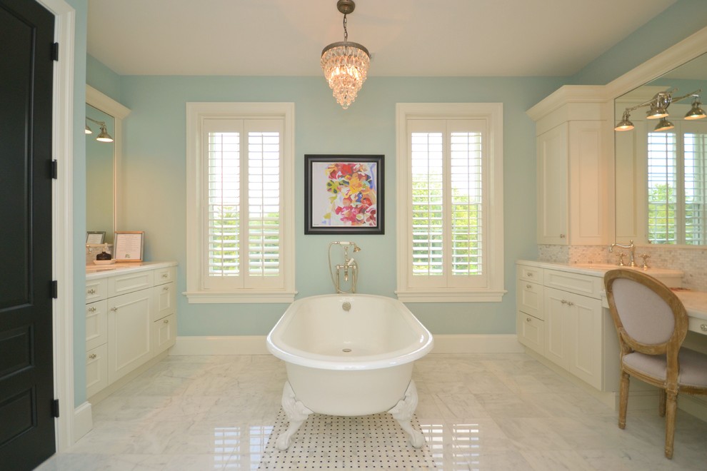 Mid-sized traditional master bathroom in Philadelphia with a drop-in sink, recessed-panel cabinets, white cabinets, marble benchtops, a claw-foot tub, a corner shower, white tile, mosaic tile, blue walls and marble floors.