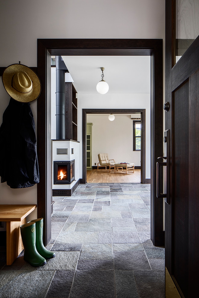 Inspiration for a transitional entryway in Tokyo with white walls, a single front door, a black front door and grey floor.