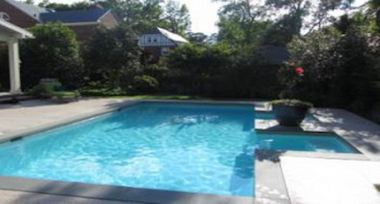 Inspiration for a mid-sized backyard concrete paver and rectangular pool remodel